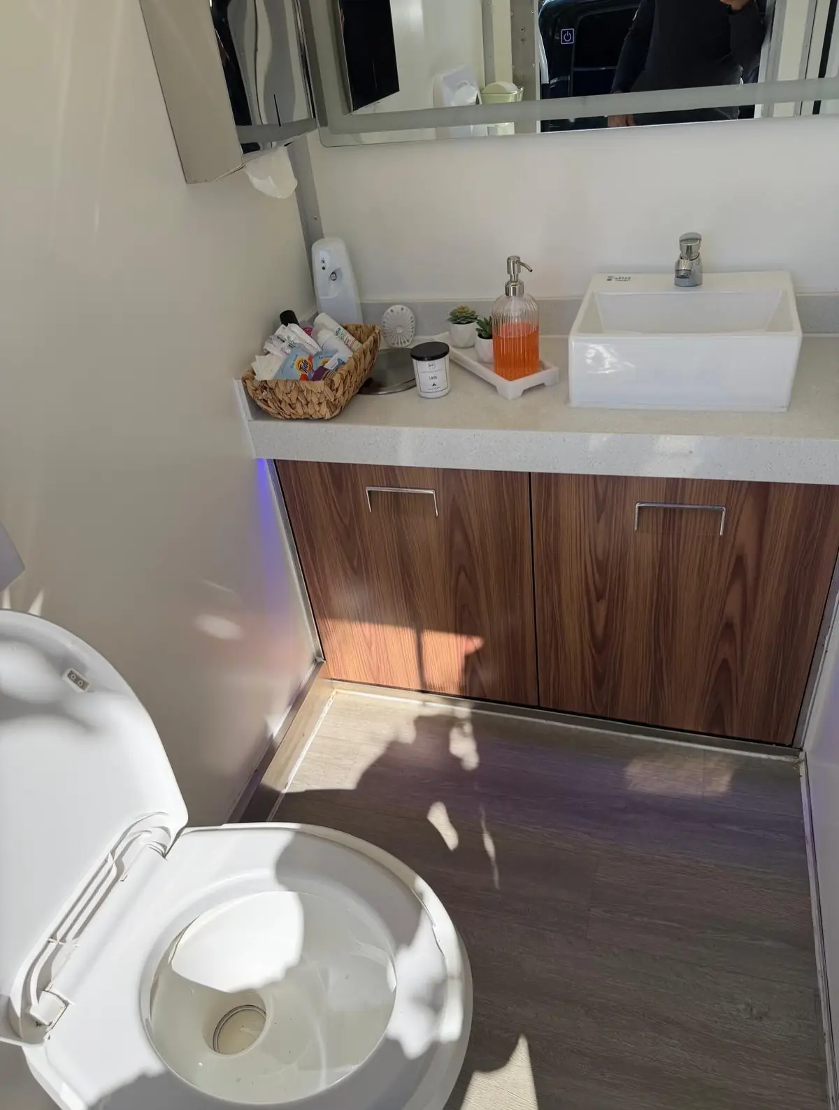 Vanity with vessel sink, mirror and soap inside a trailer